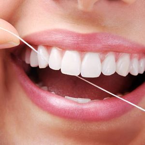 Beautiful smiling model with dental floss- XXXL Image